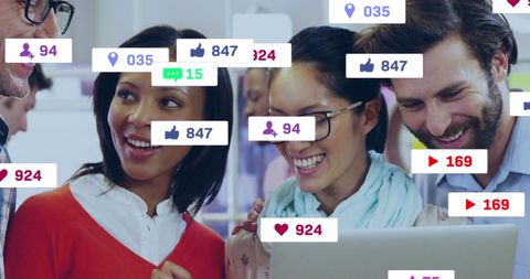 Happy Coworkers Discussing Social Media Engagement and Trends