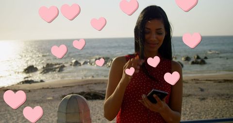 Woman Capturing Beach Moments with Smartphone and Floating Hearts
