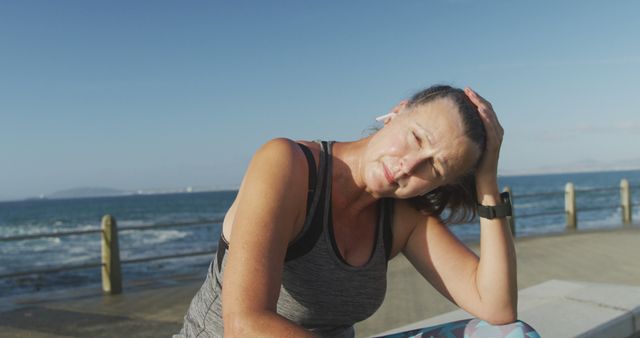 Middle-aged Woman Refreshing Post-Workout Near Oceanview - Download Free Stock Images Pikwizard.com