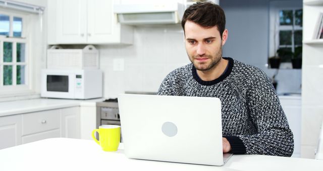 Man using laptop in the kitchen 4k