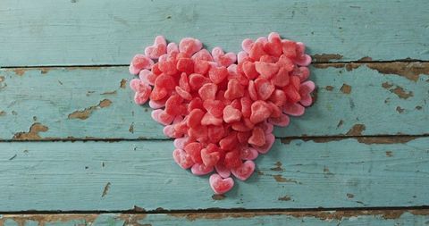 Heart Shaped Pink and Red Gummy Candies on Rustic Wooden Background