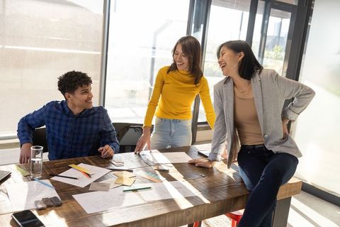 Creative Coworkers Collaborating at Workspace with Design Sketches