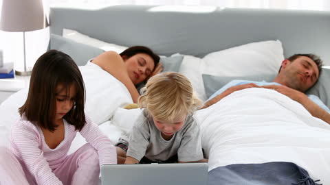 Children Entertained with Technology While Parents Resting