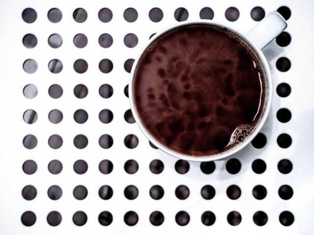 Hot Chocolate in White Mug on Polka Dot Surface - Download Free Stock Photos Pikwizard.com