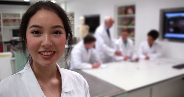 Happy asian female medical student standing and smiling in medical lab. Study time, learning, medical, scientist, knowledge and science, unaltered.