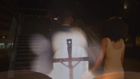 Couple Walking in Urban Nightlife with Symbolic Bokeh