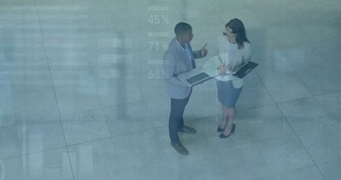 Business Professionals Discussing Strategies With Technology in Modern Office