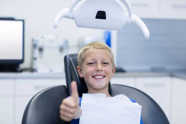 Smiling young patient sitting on dentist chair - Download Free Stock Photos Pikwizard.com