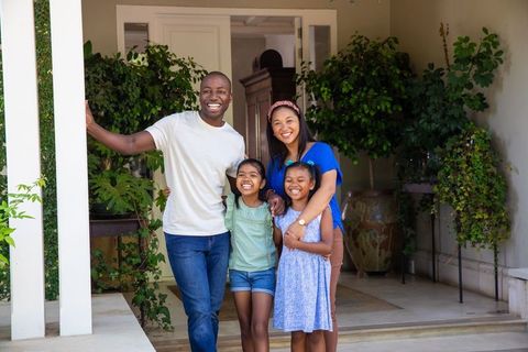 Family Enjoying Time on Front Porch Surrounded by Plants