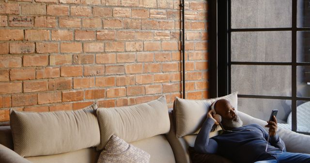 Man Relaxing on a Couch Listening to Music with Headphones - Download Free Stock Images Pikwizard.com