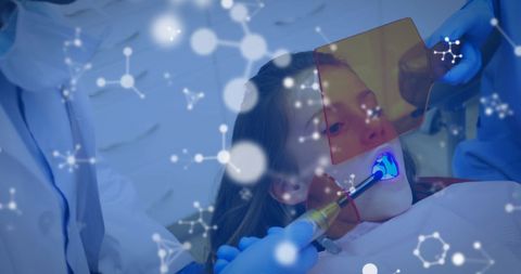 Dentist Performing Dental Procedure on Young Girl