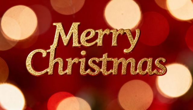 Golden glitter merry christmas text with warm bokeh lights for festive holiday greetings