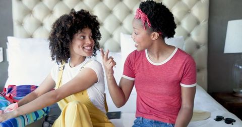 Friends sharing makeup tips during casual home gathering