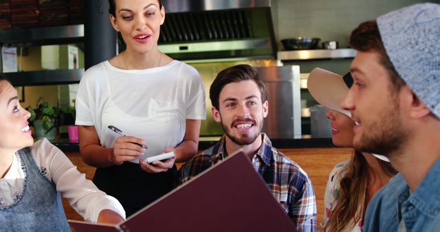 Cheerful Group of Friends Ordering Food at a Restaurant - Download Free Stock Images Pikwizard.com