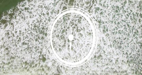Aerial drone view of ocean swell with marine hud ring pulsing, morphing, tracking