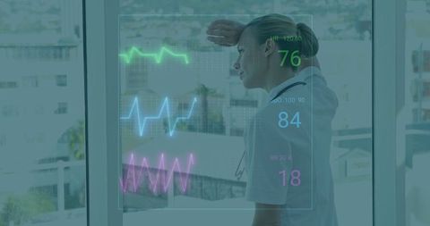 Nurse Monitoring Vital Signs With Digital Technology Overlay in Hospital