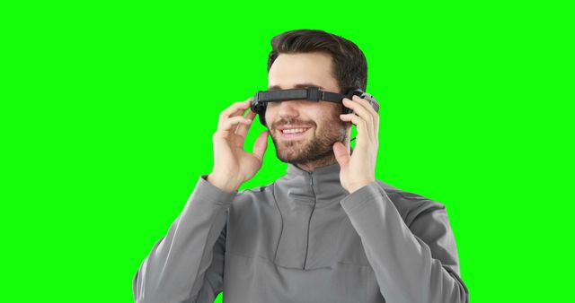 Man using virtual reality headset against green screen
