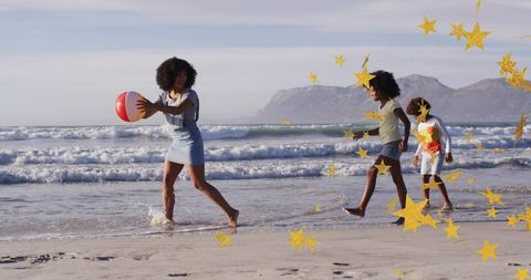 Family playing beach ball, adults and kids running through surf, golden star overlay