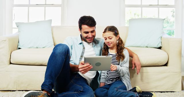 Father and Daughter Using Tablet Together in Living Room - Download Free Stock Images Pikwizard.com