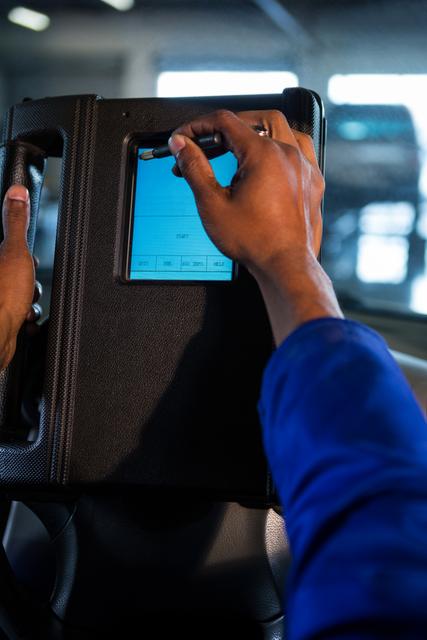 Mechanic using touchscreen device in car