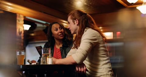 Friends Engaging in Lively Conversation at Bar - Download Free Stock Images Pikwizard.com