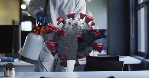 Technician disinfecting modern office from 3d virus