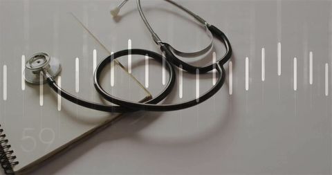 Stethoscope with sound wave visual over medical journal