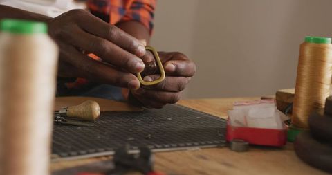 Skilled artisan crafting belt in leather workshop close-up