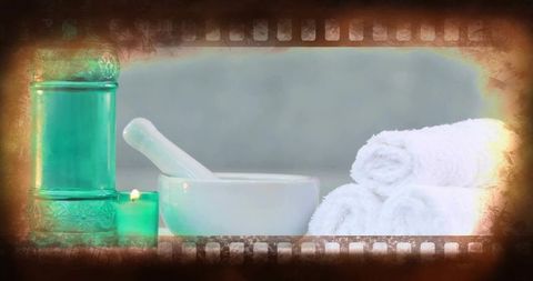 Soothing spa still life with mortar and pestle, rolled towels and tealight, vintage vignette