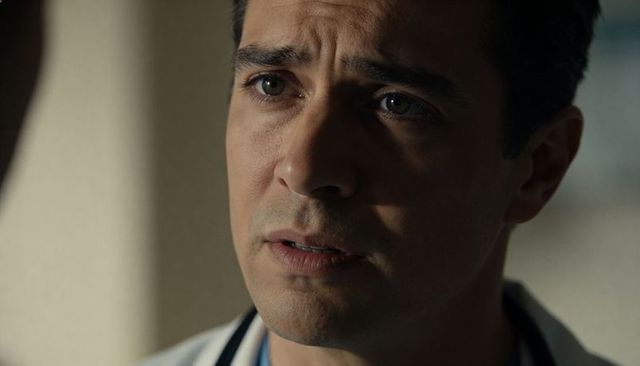 Concerned male physician closeup portrait showing empathy and clinical focus