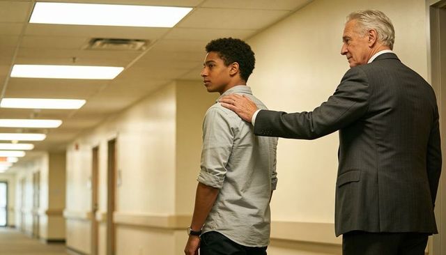 Senior professional guiding teen through long corporate corridor mentorship and support