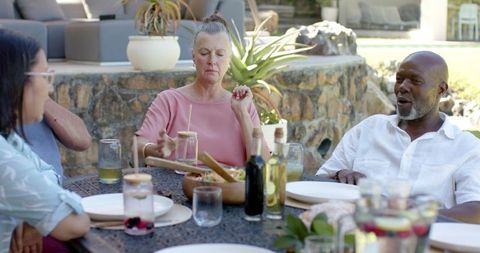 Diverse friends enjoying al fresco dining with salad