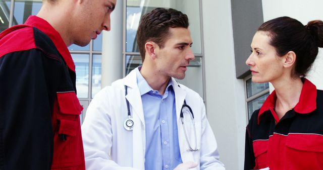 Doctor Consulting Emergency Responders Outside Hospital - Download Free Stock Images Pikwizard.com