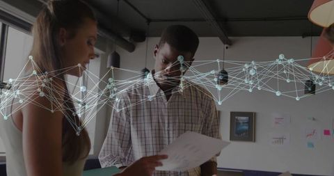 Coworkers Analyzing Charts with Digital Network Overlay