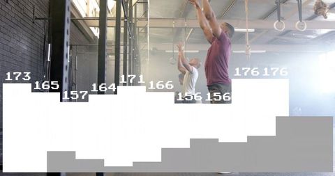 Athletes training with pull-up bar in industrial gym setting