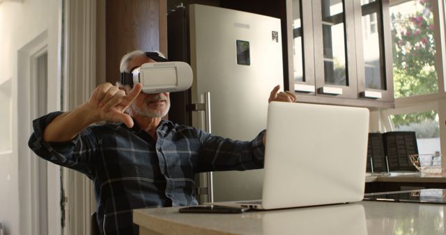 Older Man Using Virtual Reality Headset with Laptop in Modern Kitchen - Download Free Stock Images Pikwizard.com
