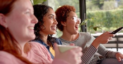 Diverse Female Friends Relaxing and Laughing Together at Home