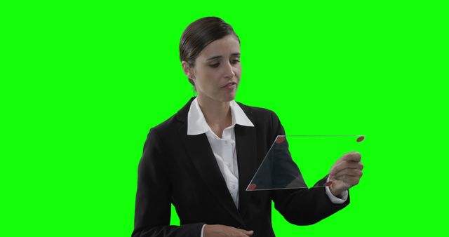 Businesswoman using transparent virtual tablet with green screen background - Download Free Stock Images Pikwizard.com