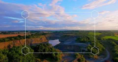 Framed scenic landscape at sunset with green hills