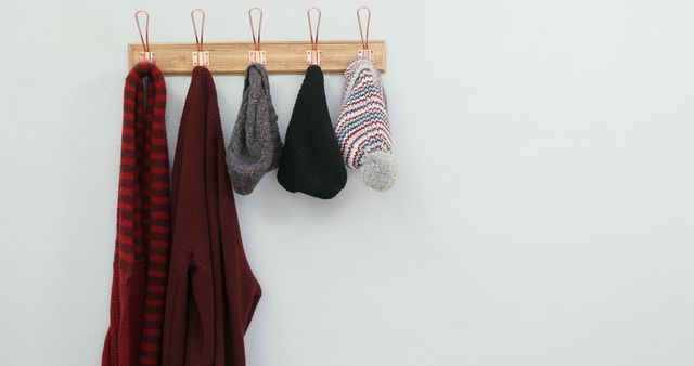 Cozy Winter Clothes Hanging on Wall Hooks in Neat Arrangement - Download Free Stock Images Pikwizard.com