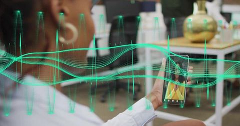 Woman Holding Smartphone with Neon Green Waveform Overlay in Coworking for Audio Visualization