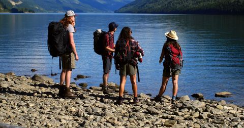 Young Hikers by Scenic Lake Enjoying Outdoor Adventure