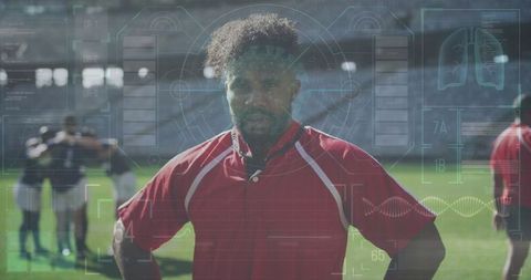 Rugby player in red jersey with teammates on stadium field