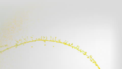 Yellow Water Splash Forming Arc on Grey Background in Slow Motion