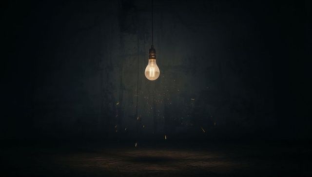 Dimly lit incandescent bulb in dusty industrial ambiance