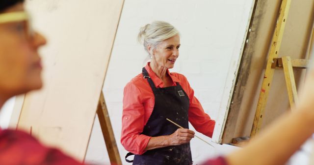 Senior Woman Painting in Art Classroom - Download Free Stock Images Pikwizard.com