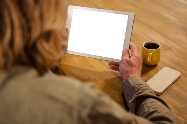 Woman Holding Digital Tablet in Cafe with Yellow Cup and Transparent Screen - Download Free Stock Videos Pikwizard.com