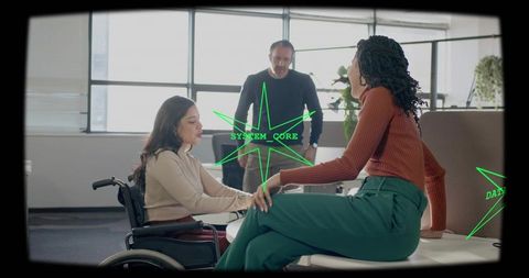 Wheelchair user collaborating with colleague in bright office emphasizing inclusion