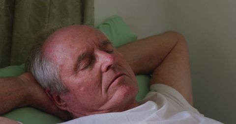 Senior Man Peacefully Sleeping in Bedroom Setting