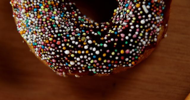 Close up of donut with hundreds of thousands sprinkle with copy space. Dessert, food, sweets, sugar and eating concept, unaltered.